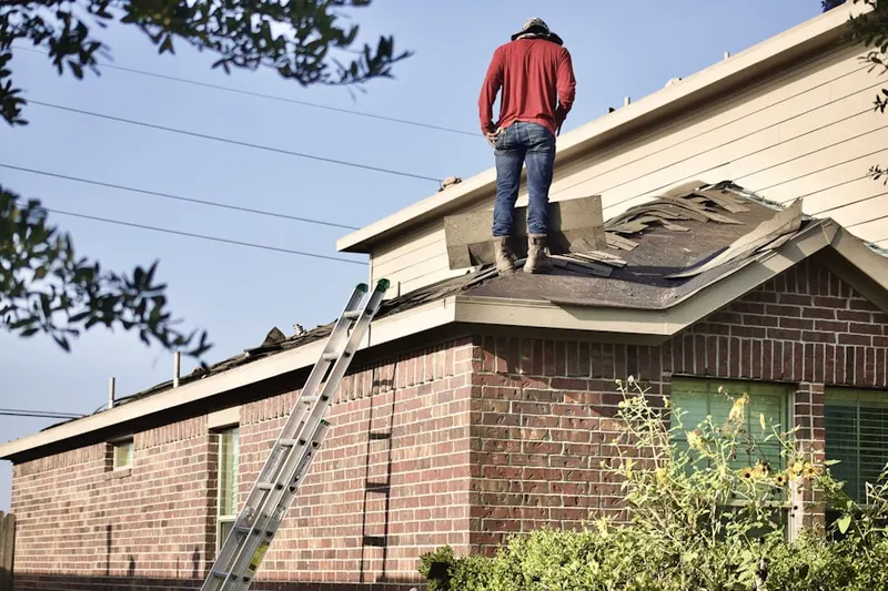 Professional roofer working on a residential roof in Hakes Corners